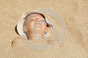 Child buried in the sand