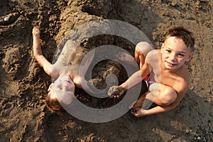 Child buries his brother in sand