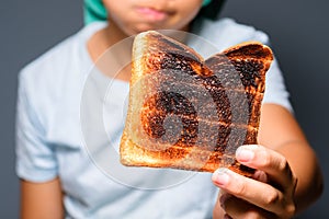 Child with burnt toast