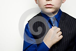 Child in Business Suit Adjusting Tie