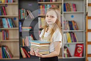Child buys books in bookstore for learning or reading. Girl choosing book in school library