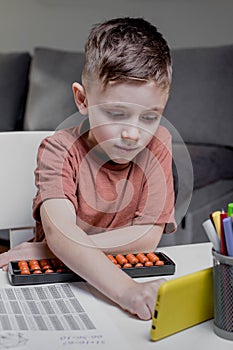 Child calculates an arithmetic problem orally. Mental arithmetic. Portrait of a boy doing mathematics
