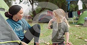Child, camp counsellor and high five with support from a girl on camping trip, Goals, smile and team building success