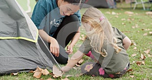 Child, camp counsellor and tent help outdoor with support from a girl while camping, Nature, smile and survival
