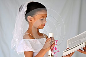 Child with candle and rosary beads