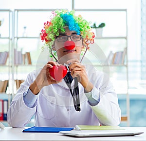 Child cardiologist with stethoscope and red heart