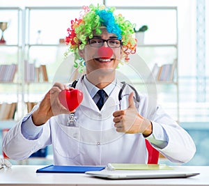 Child cardiologist with stethoscope and red heart