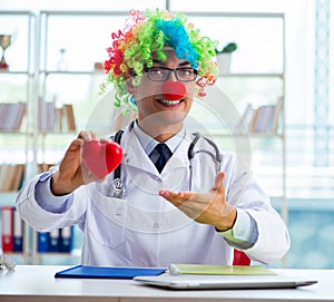 Child cardiologist with stethoscope and red heart