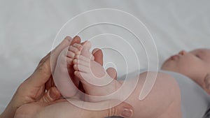 Child Care. Closeup Of Loving Mother Playing With Newborn Baby's Tiny Feet