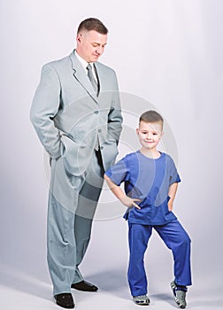 Child care development upbringing. Respectable profession. Man respectable businessman and little kid doctor uniform