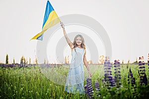 Child carries fluttering blue and yellow flag of Ukraine