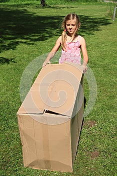 Child carrying a box