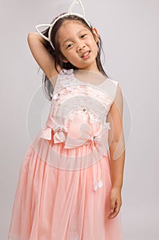 Child with Cat Ear Headband in Pink Dress, Isolated on White