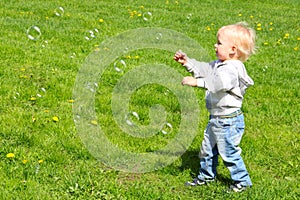 Child catching soap bubbles