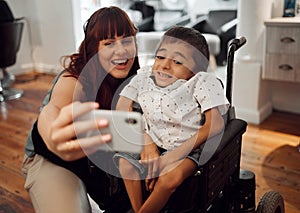 Child, cerebral palsy and happy phone selfie of a mobile disability boy in a wheelchair. Woman or mother smile with a