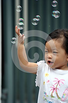 Child chasing bubbles