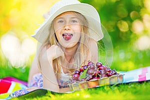 Child with cherries. Little girl with fresh cherries. Portrait of a smiling young girl with bowl full of fresh cherries