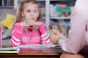 Child chooses the color pencils