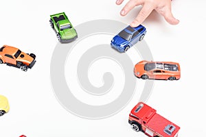 Child chooses his favourite toy car from selection of toys