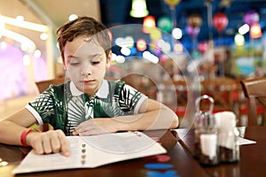 Child choosing dish in menu