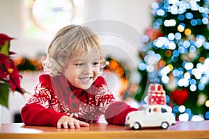 Child with Christmas present. Kid with Xmas gift