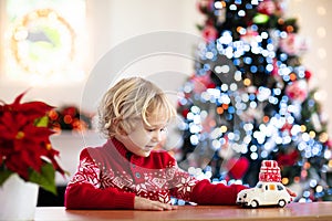 Child with Christmas present. Kid with Xmas gift