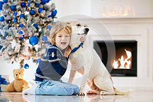 Child at Christmas tree. Kids at fireplace on Xmas