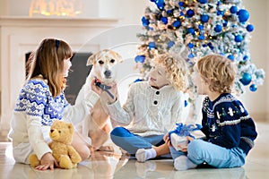 Child at Christmas tree. Kids at fireplace on Xmas