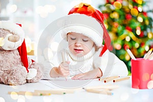 Child before Christmas writes a letter to Santa