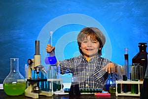 Child in the class room with blackboard on background. Learning at home. Chemistry The Science Classroom. Little kids