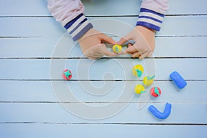 Child with Clay and using creativity for making fruit,Such as orange and etc.