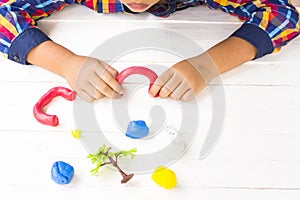 Child with Clay and using creativity for making red door of garden and etc.Top view and Zoom in.