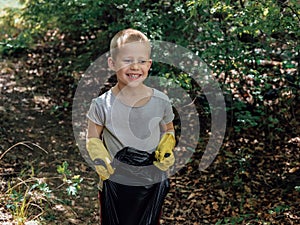 The child cleans the forest of debris