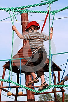 Child climbing in adventure playground
