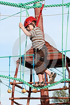 Child climbing in adventure playground