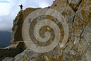 A child climbing on a hight rock wall