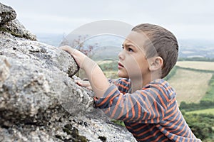 Child climbing on rock