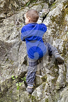 Child climbing a rock