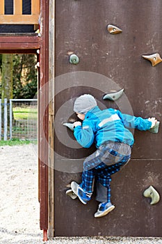 Child climbing a wall in a playground