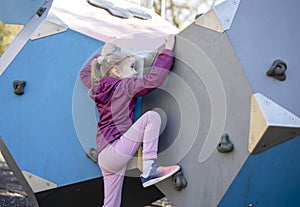 Child on climbing-wall in playground