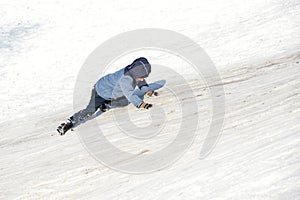 A child climbs a snow slide for sledging