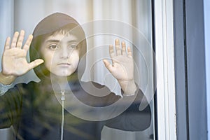 Child through a close window pane