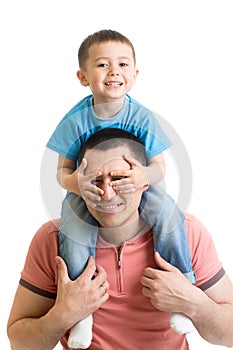 Child closes hands eyes father. Happy little boy enjoying with riding on father`s back. Happy family portrait. Laughing