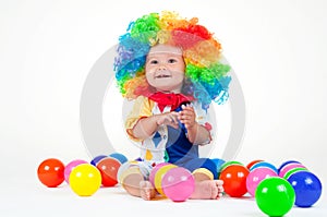 Child clown with a red nose multicolored wig in with balls