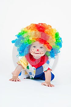 Child clown with a red nose multicolored wig in with balls