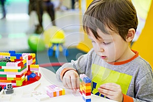 The child collects the Designer. Kids activity in kindergarten or at home. Child plays with a children`s designer