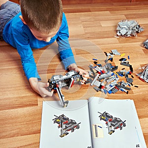 Child collects plastic toy building kit