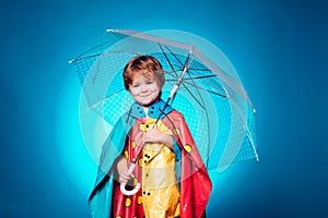 Child with color umbrella on blue sky. Autumn copy spaceAutumn trend and autumn vogue. Ready for text. Autumn Dress