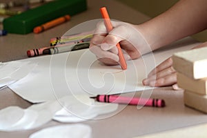 Child Coloring on Blank White Paper with Color Crayons