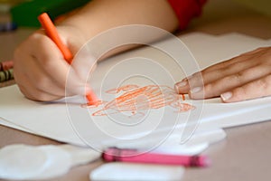 Child Coloring on Blank White Paper with Color Crayons